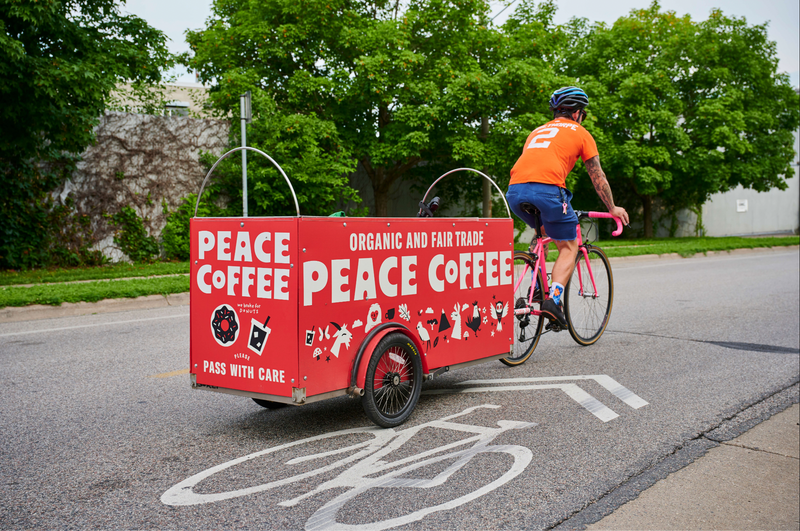 Peace Coffee bike delivery rider with cargo trailer